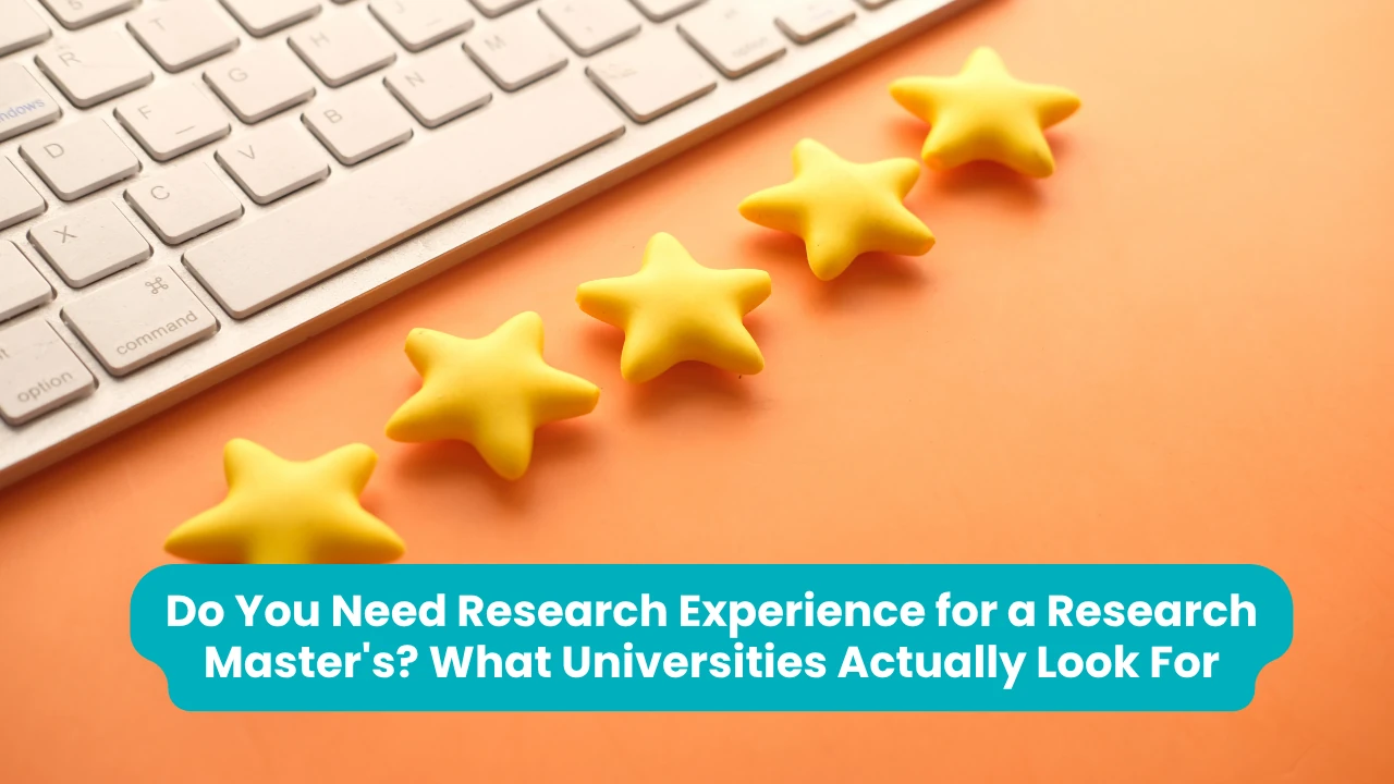 Banner reading 'Do You Need Research Experience for a Research Master's? What Universities Actually Look For' across a photograph of five yellow star shapes arranged in a rising curve on an orange surface beside a white keyboard