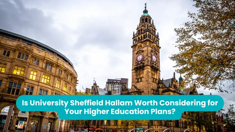 A Victorian sandstone clock tower with a green copper spire beside a curved stone civic building, photographed from below against a pale sky with autumn leaves at the right