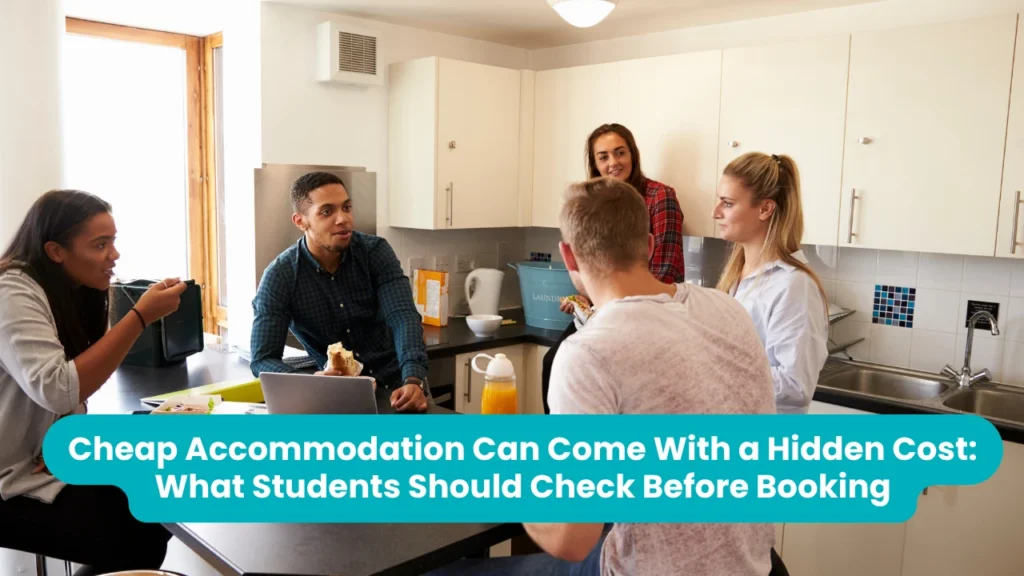 Banner reading 'Cheap Accommodation Can Come With a Hidden Cost: What Students Should Check Before Booking' across a photograph of five students talking around a table in a shared student kitchen, with a laptop, sandwiches and a juice bottle in front of them