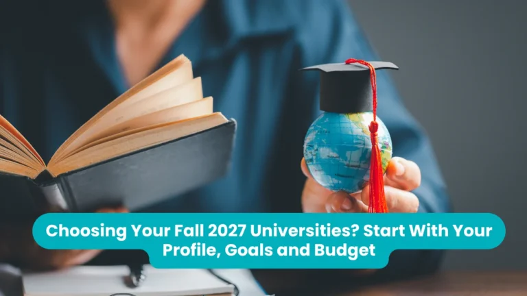 Banner reading 'Choosing Your Fall 2027 Universities? Start With Your Profile, Goals and Budget' across a photograph of a person holding an open book in one hand and a small globe wearing a black graduation cap with a red tassel in the other