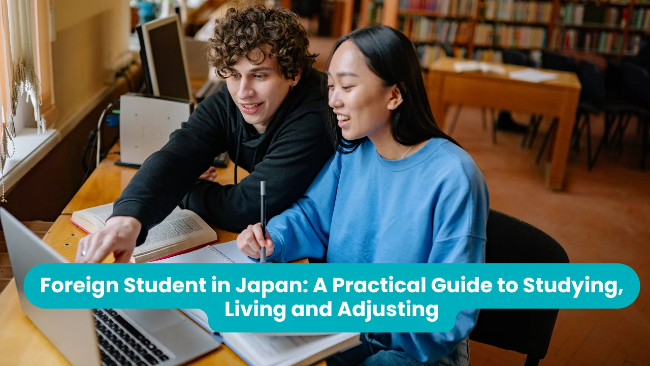 Banner reading 'Foreign Student in Japan: A Practical Guide to Studying, Living and Adjusting' across a photograph of two students in a library, a young man in a black hoodie pointing at a laptop screen beside a smiling young woman in a blue sweatshirt holding a pen