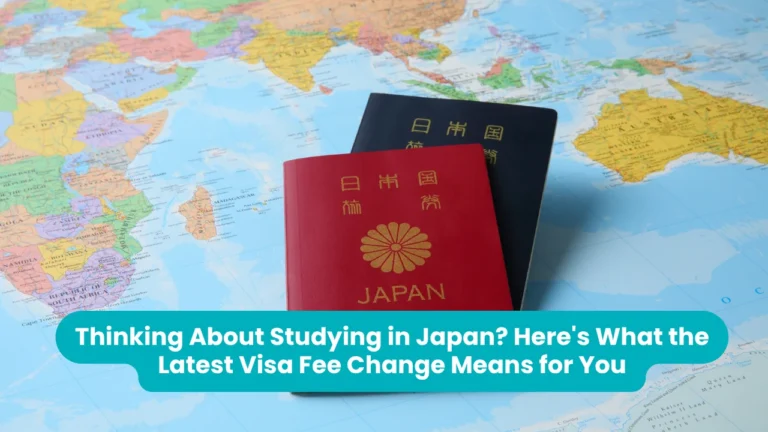 Banner reading 'Thinking About Studying in Japan? Here's What the Latest Visa Fee Change Means for You' across a photograph of two Japanese passports, one red and one dark blue, resting on a colourful world map