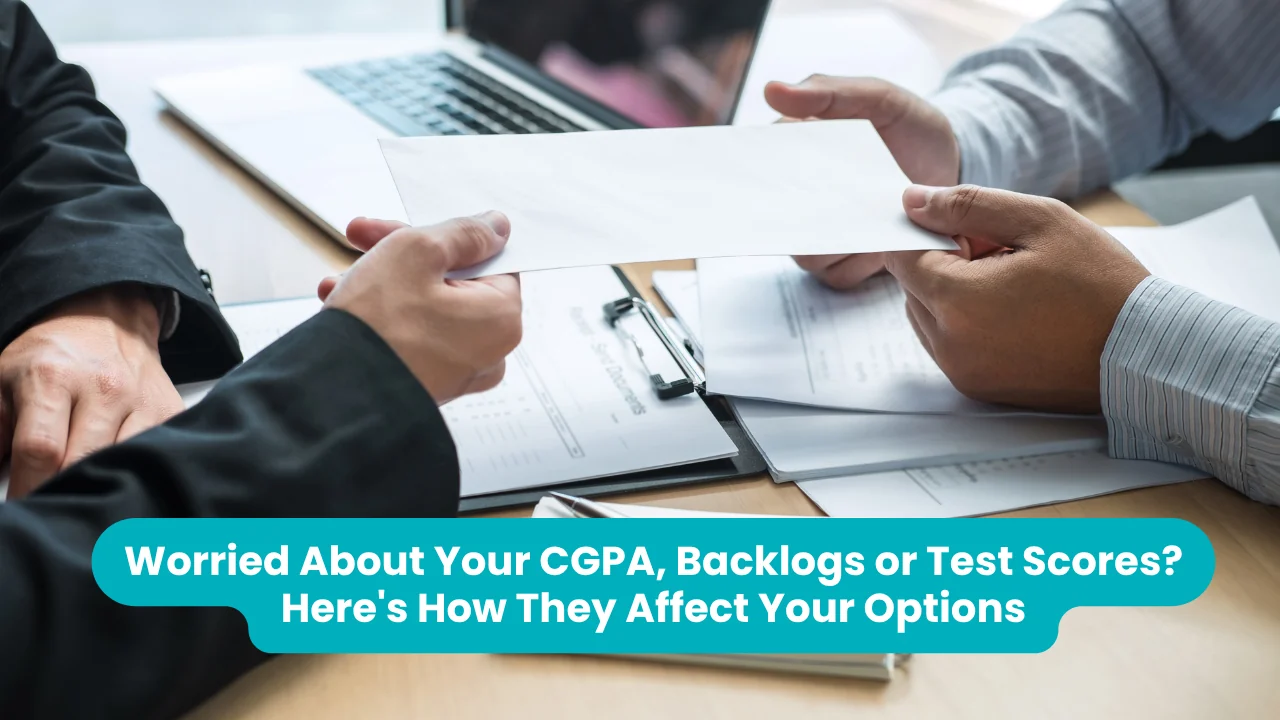 Banner reading 'Worried About Your CGPA, Backlogs or Test Scores? Here's How They Affect Your Options' across a photograph of two people passing a document across a desk covered with application forms, a clipboard and an open laptop