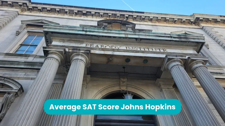 Banner reading 'Average SAT Score Johns Hopkins' across a low-angle photograph of the columned stone entrance of the Peabody Institute, part of Johns Hopkins University in Baltimore, against a blue sky